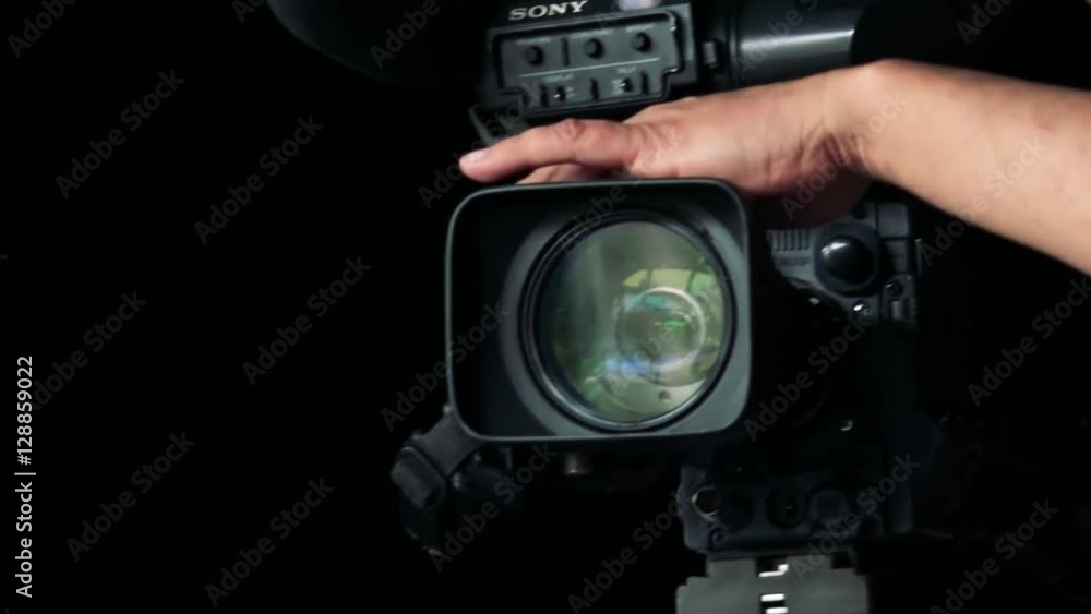 Close - up lens of black camera - man works with camera