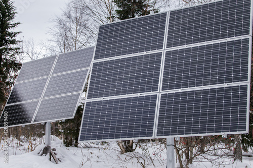 Solar panel plant in cloudy weather in the winter forest