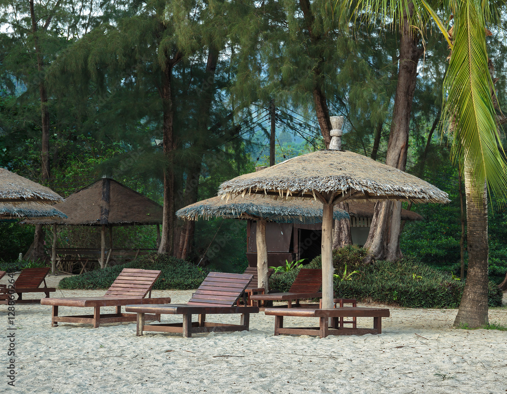 Lounge chairs and sunshade umbrella on the beach