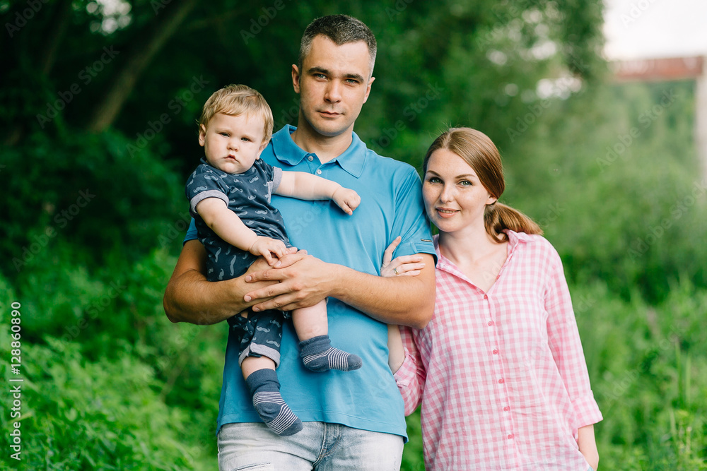 Fototapeta premium family with baby on the nature in the summer near the river