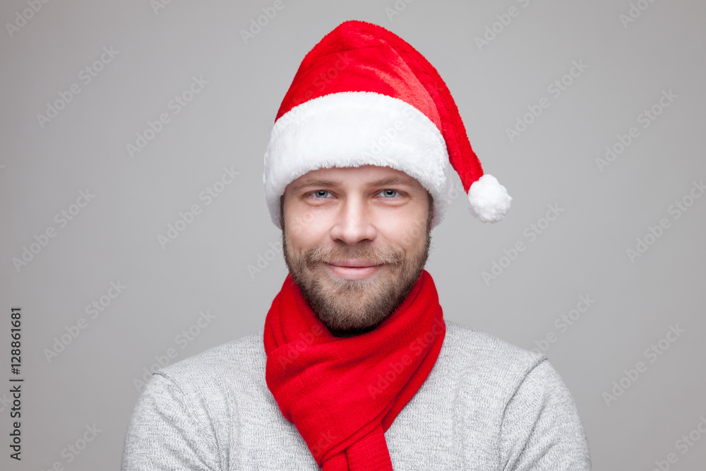 Handsome man with beard wearing a Christmas hat Handsome man with beard wearing a Christmas hat