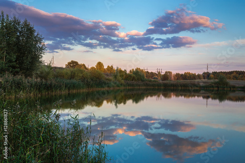 Pond in countryside in autumn at sunset