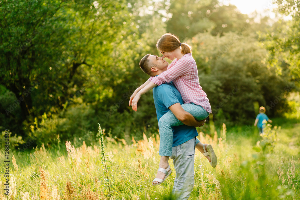 happy couple on a walk in the summer park happy couple on a walk in the summer park