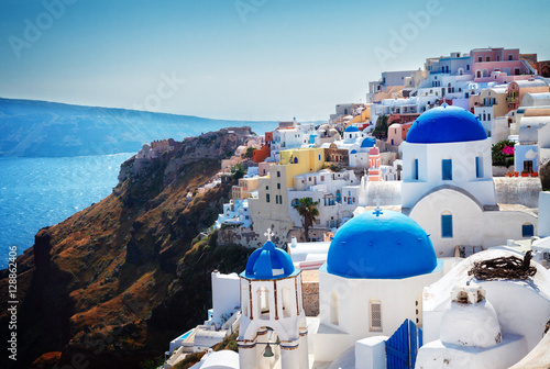 Oia, traditional greek village of Santorini with blue domes of churches, Greece, retro toned