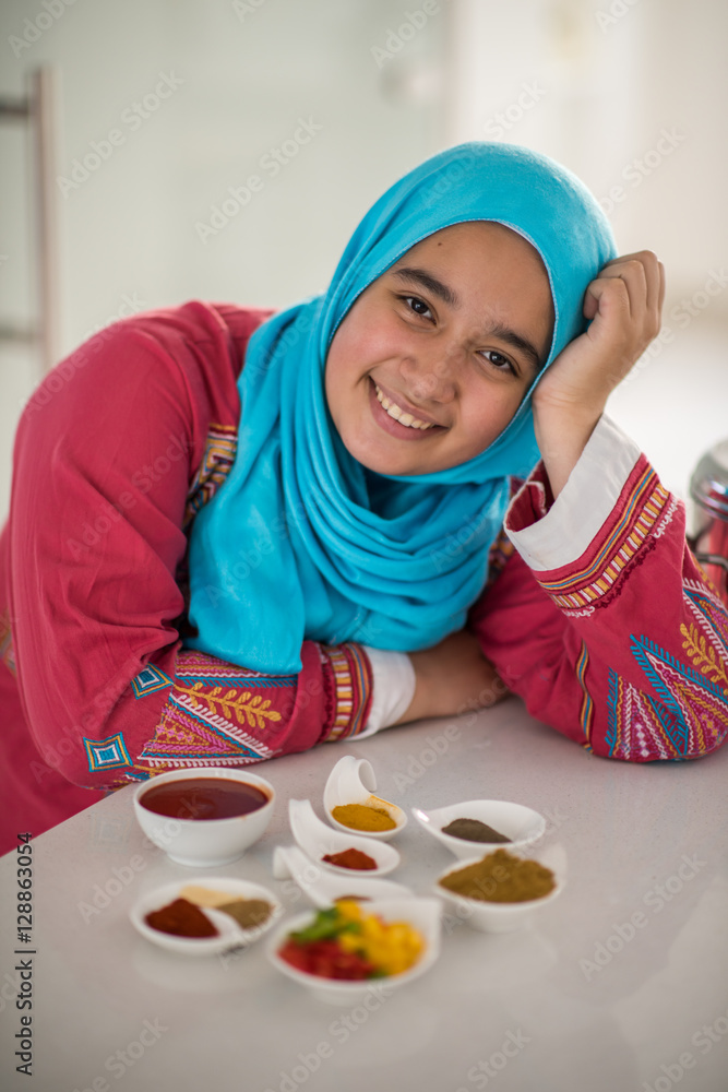 Muslim traditional woman working in kitchen Muslim traditional woman working in kitchen