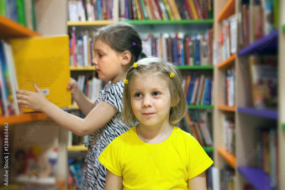 preschoolers choosing books at library. preschoolers choosing books at library.