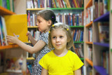 preschoolers choosing books at   library.