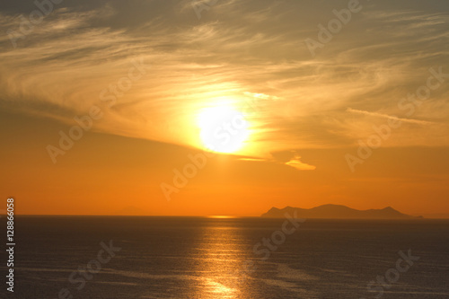 Fototapeta Naklejka Na Ścianę i Meble -  Sunset in Oia, Santorini. Volcano caldera on background. Horizon