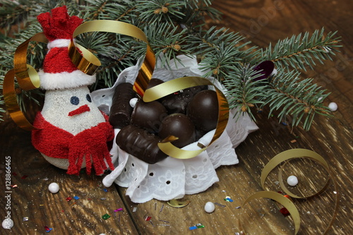 Snowman near the Christmas tree and candy photo