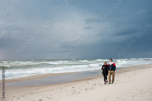 Man and a woman walking on the sea