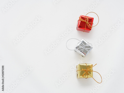 Red, silver, and gold gift boxes on isolated white background