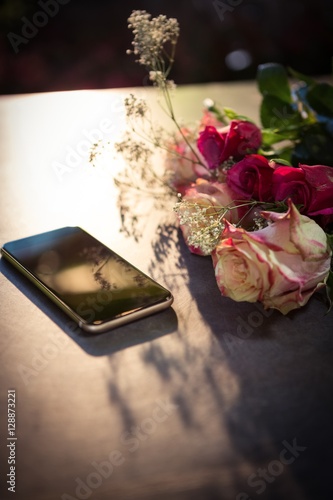 Roses and smartphone on the table