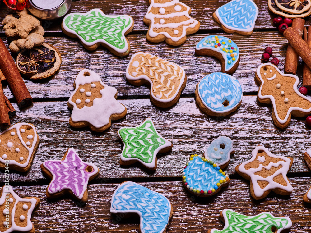 Christmas background gingerbread cookies and cinnamon sticks on woden table . Christmas background gingerbread cookies and cinnamon sticks on woden table .