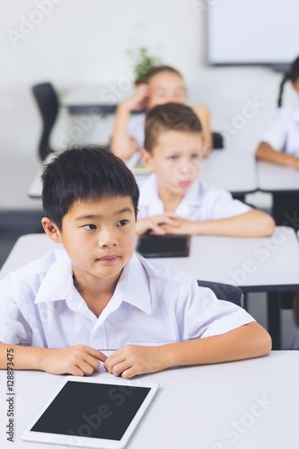 Schoolboy sitting in classroom