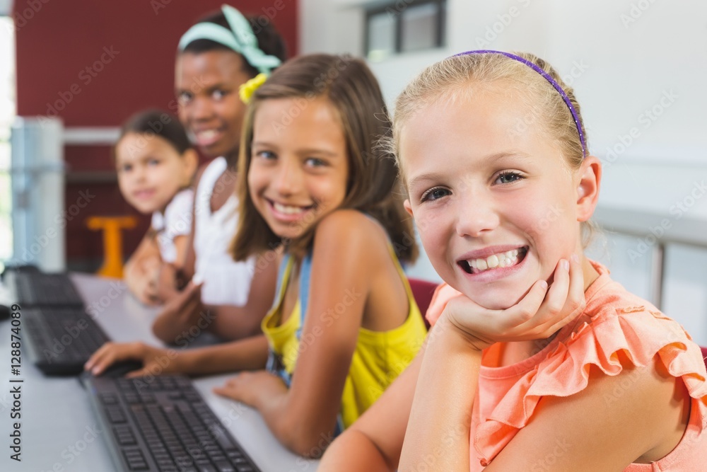 Happy schoolgirls smiling in classroom Happy schoolgirls smiling in classroom