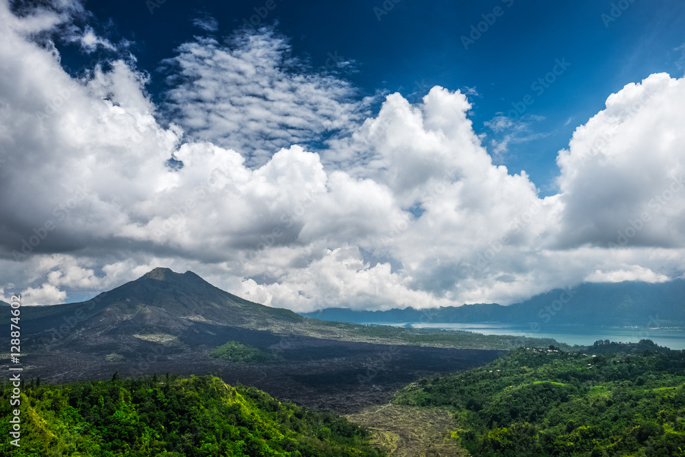 Caldera of the volcano of Batur at sunny day with clouds. Bali island, Indonesia