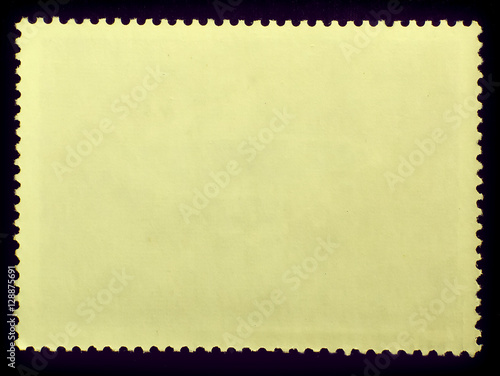 Posted stamp reverse side with the edge of the sheet. Texture of paper.Isolated on black background