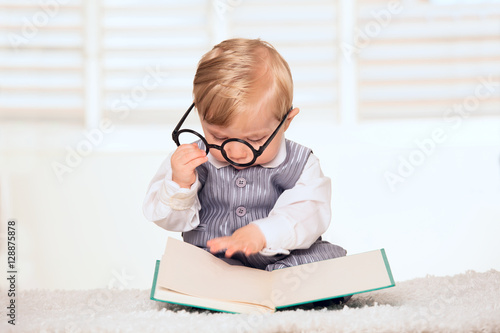 Nerdy baby boy reading a book