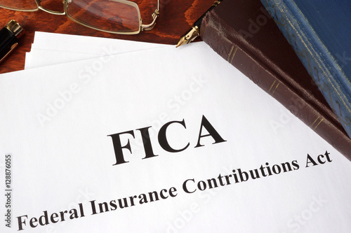 Papers with FICA Federal Insurance Contributions Act tax. photo