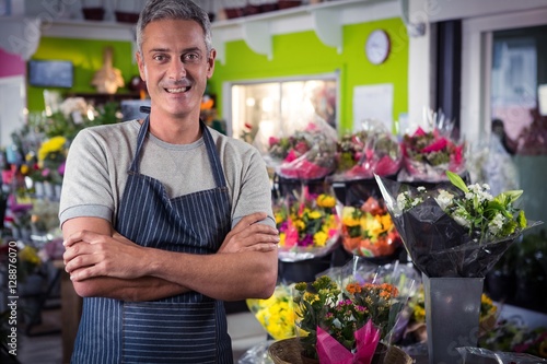 Male florist standing with arms crossed