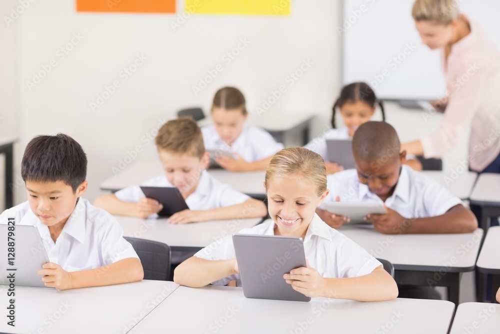 Students using digital tablet in classroom Students using digital tablet in classroom