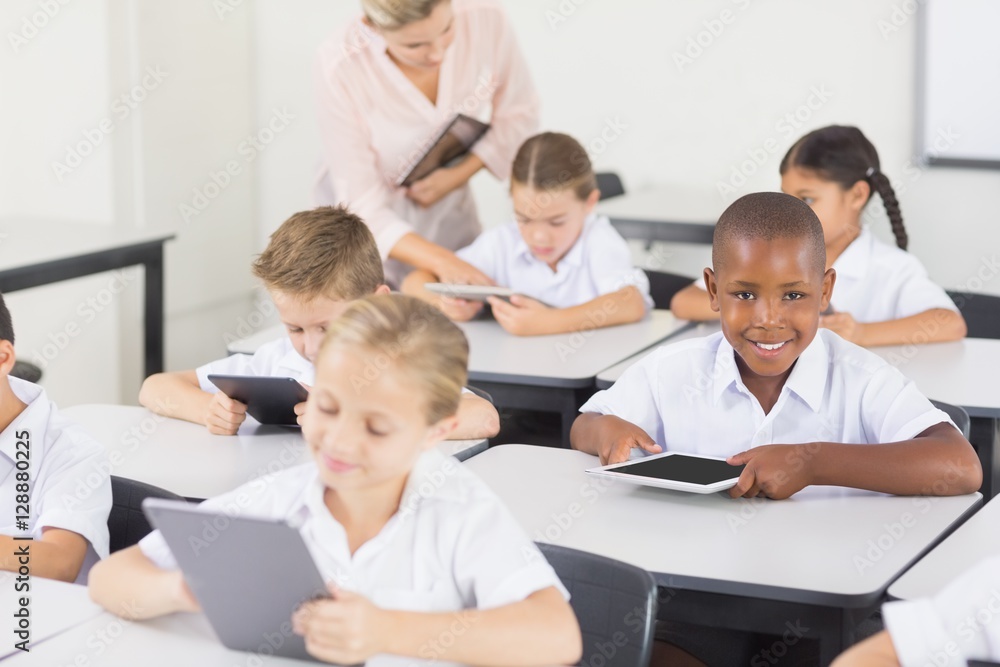 Students using digital tablet in classroom