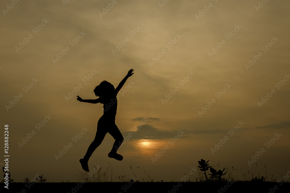 Silhouette image of a girl jumping on the road with a sunset background. Silhouette image of a girl jumping on the road with a sunset background.