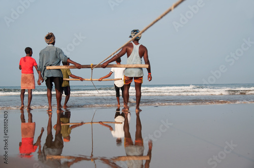 Village fisherman catching netfishing photo