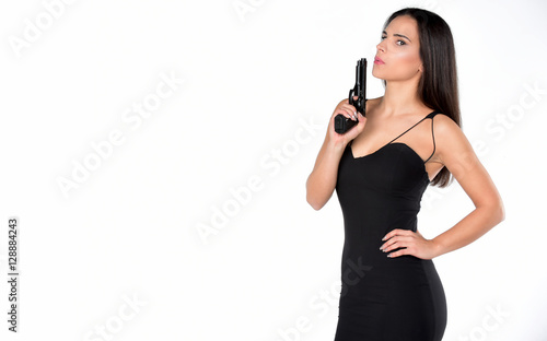 beautiful dangerous women holding a gun. isolated on white background