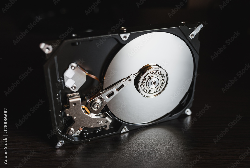 Disassembled hard drive from the computer, hdd with mirror effect. Opened hard  drive from the computer hdd with mirror effects. Part of computer pc,  laptop Stock Photo | Adobe Stock