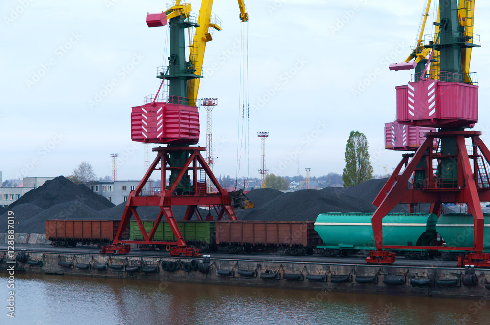 Naklejka premium Port cranes. Port terminal logistics. Freight cars to the river or sea port. Kaliningrad, Russia