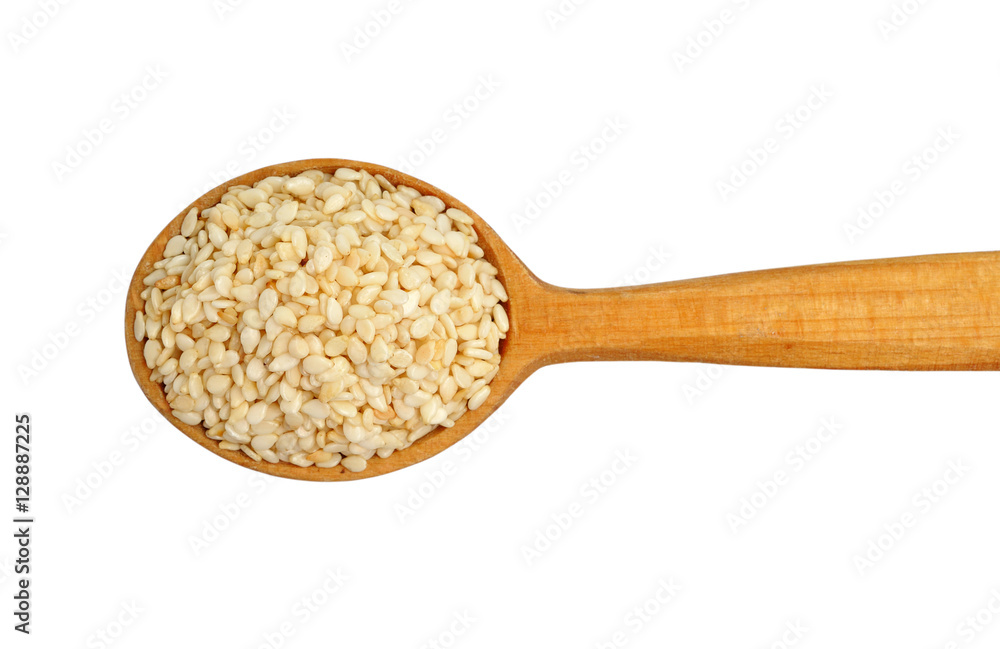 Sesame seeds on wooden spoon isolated on white background Sesame seeds on wooden spoon isolated on white background