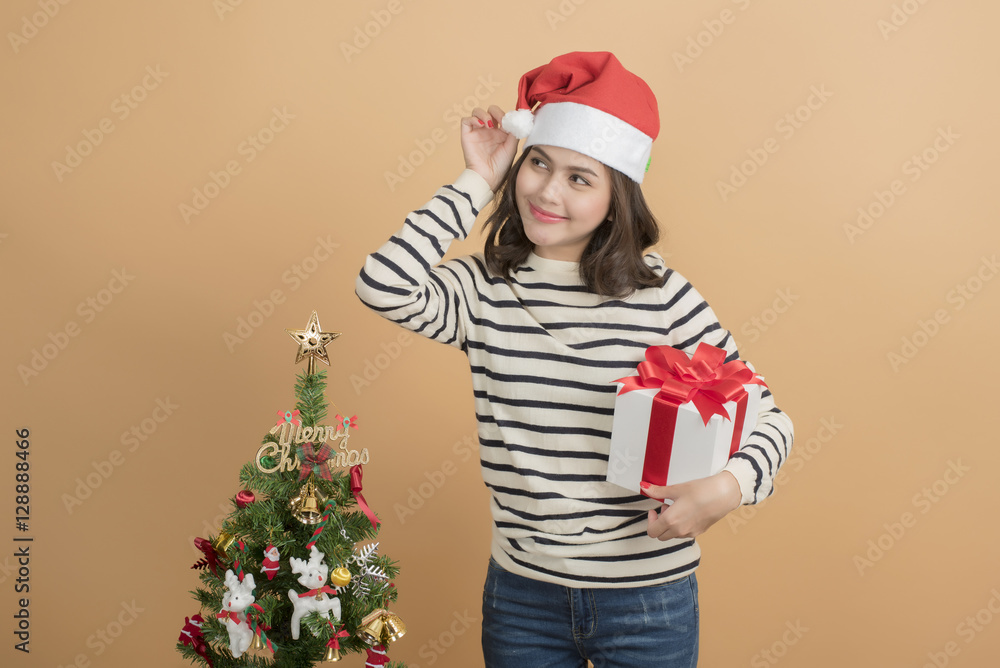 Beautiful christmas girl in santa hat with boxes on autumn back Beautiful christmas girl in santa hat with boxes on autumn back