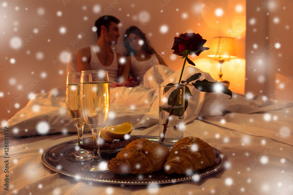 Couple in love having romantic supper in bedroom on xmas