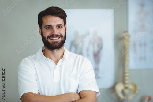Portrait of physiotherapist standing with arms crossed photo