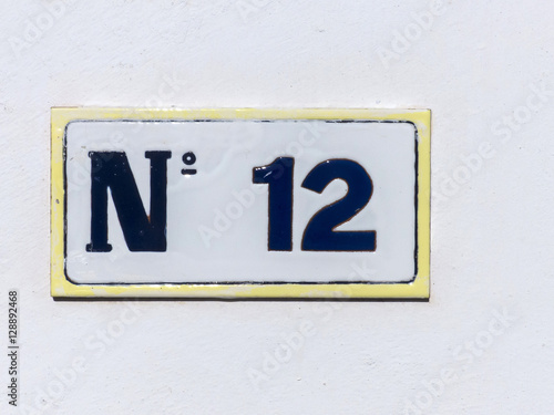 Street sign reading the number twelve.