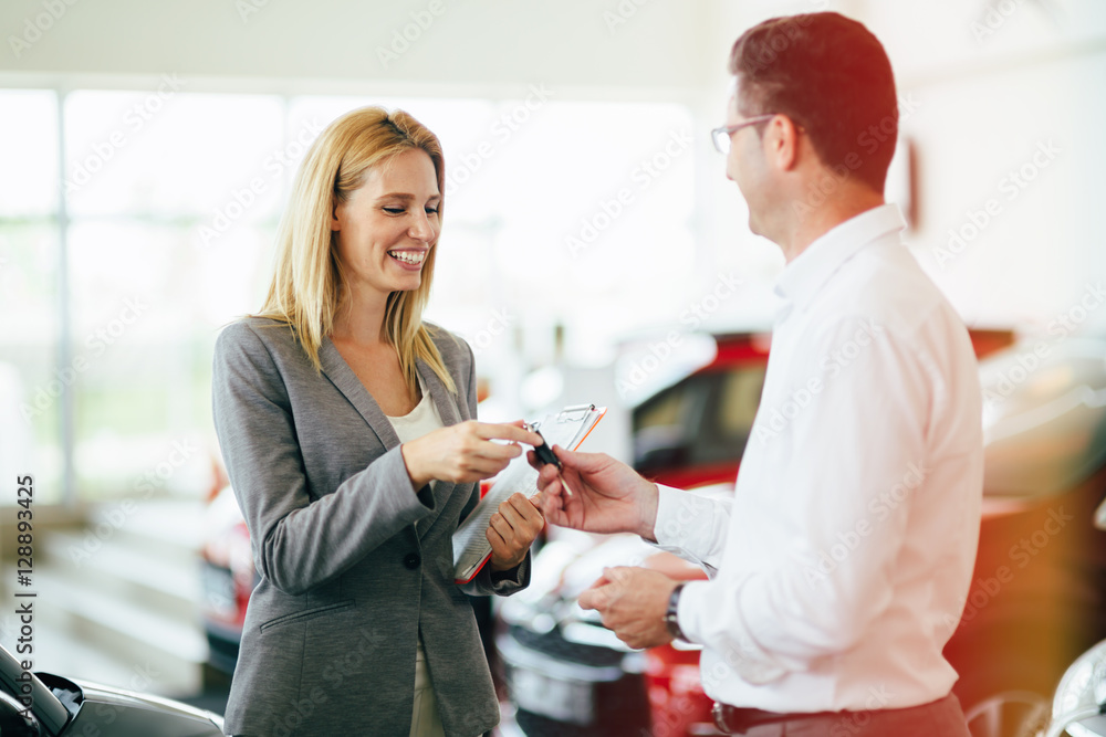 Salesperson selling cars at dealership Salesperson selling cars at dealership