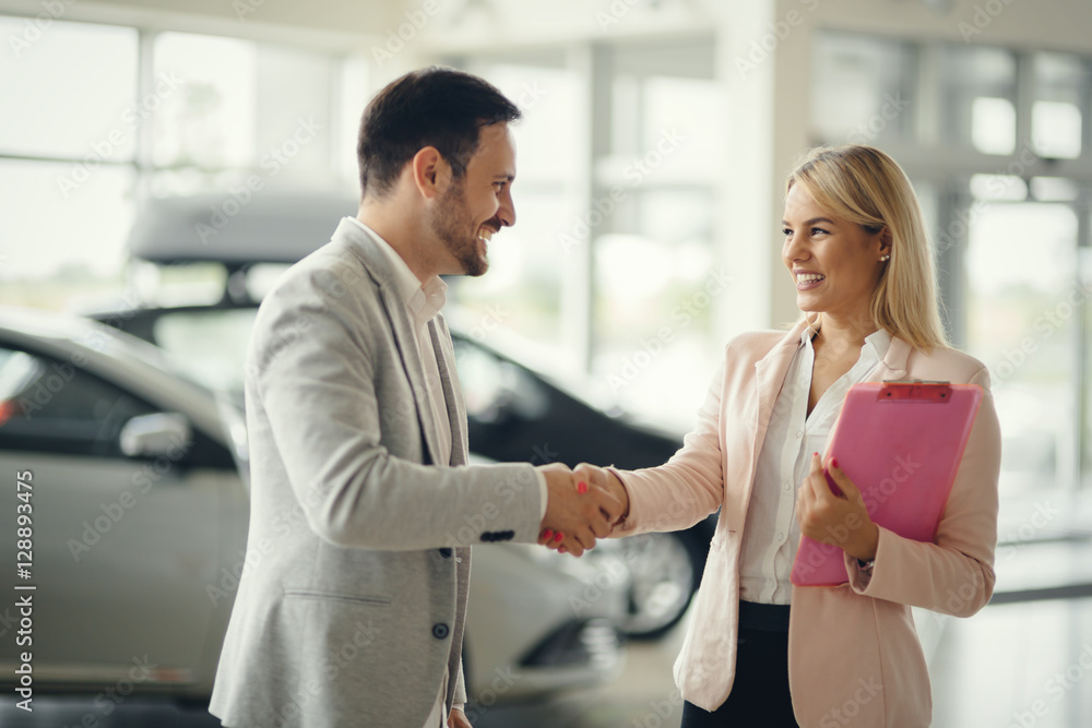 Salesperson workin at car dealership Salesperson workin at car dealership