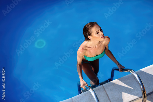 Sexy woman enjoying summer in pool