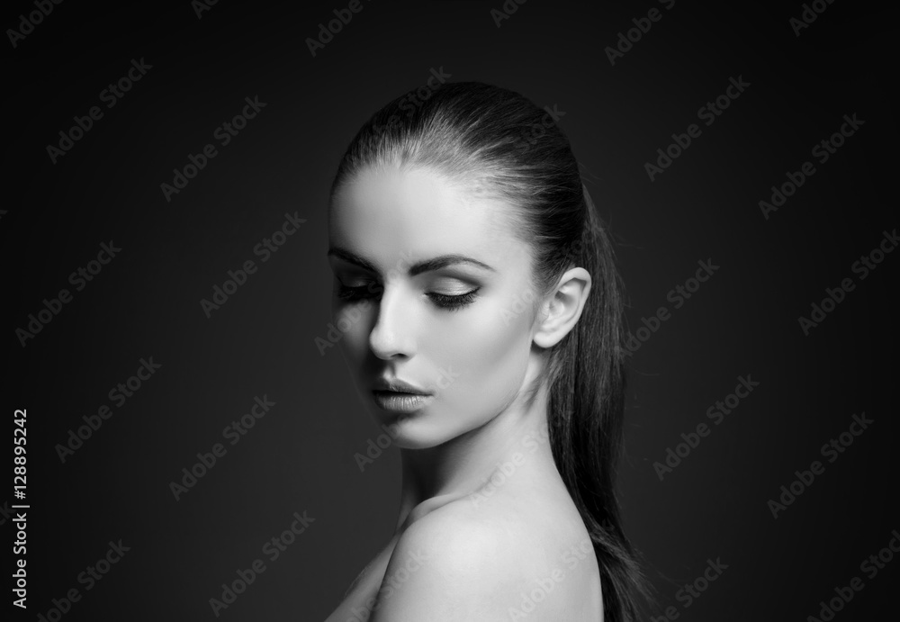 Beauty portrait of a young woman on grey Beauty portrait of a young woman on grey