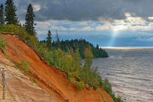 Bild auf Leinwand Нigh steep coast of Lake Onega at sunset during a storm.