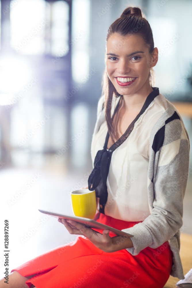 Portrait of smiling woman holding digital tablet in office Portrait of smiling woman holding digital tablet in office