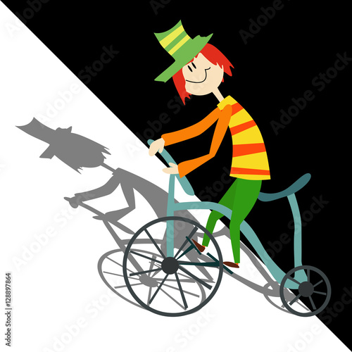 Happy boy in colorful clothes riding a bike.