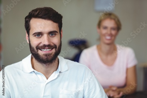 Male therapist smiling in clinic