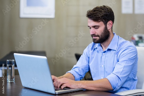 Male therapist using laptop