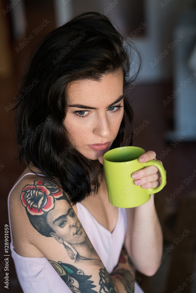 Young woman holding green mug