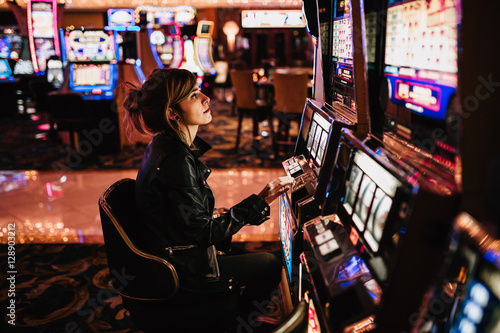 Woman playing slot machine photo