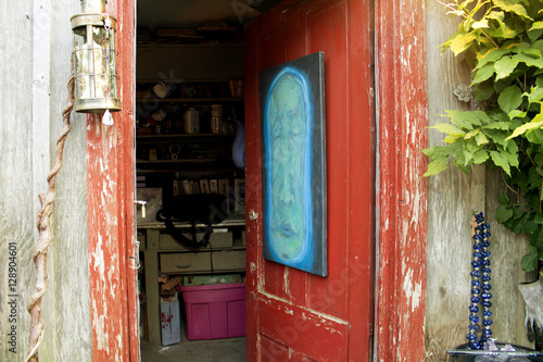 Rustic red door to artist's shack.