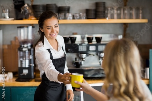 Waitress offering a cup of coffee photo