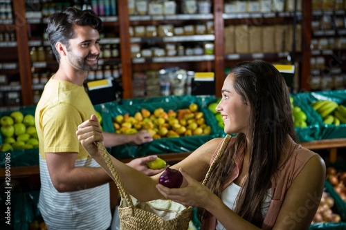 Smiling couple interacting with each other in organic section